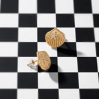 Gold-tone scallop shell stud earrings with raised lines and crystal accents